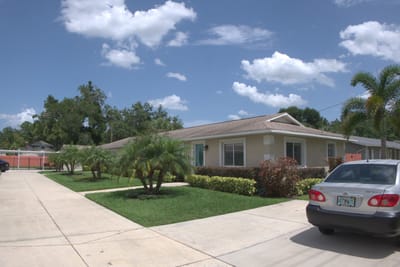 Exterior view of a senior living facility with landscaping