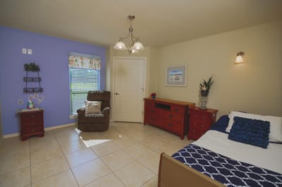 Private resident room with a cozy chair and decor