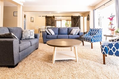 A cozy common area with sofas and chairs