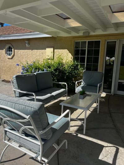 Outdoor seating area with comfortable chairs and plants