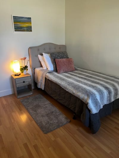 Cozy private resident room with bed and decor