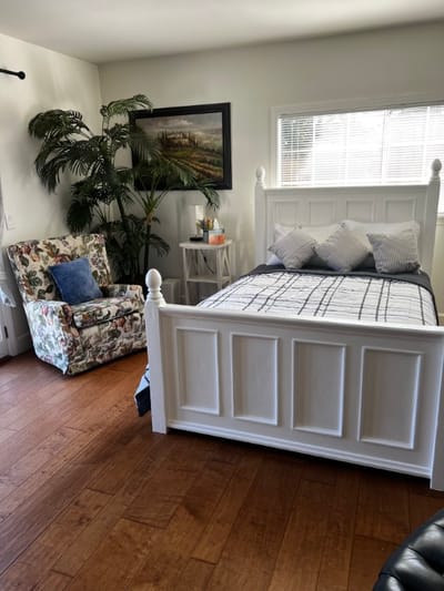 Cozy private resident room with a bed and chair