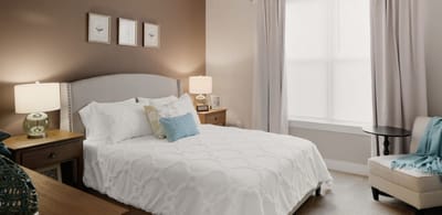 Cozy resident room with a bed and seating