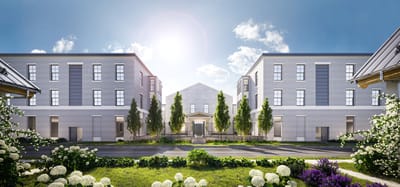 Exterior view of a senior living facility with landscaped gardens