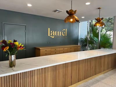 Bright interior lobby with reception desk and flowers