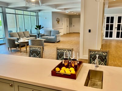 Bright common area with seating and a kitchen island