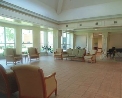 Bright common area with seating and large windows