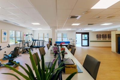 A spacious and well-lit activity room with equipment