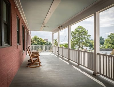 Outdoor porch with rocking chairs overlooking a garden