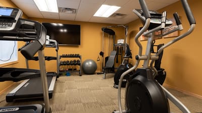 Well-equipped fitness room with various exercise machines