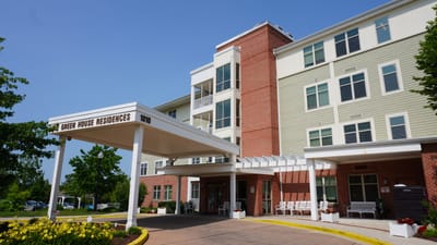 Exterior view of Green House Residences with entrance and landscaping