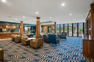 Common area with seating and large windows overlooking outdoor space