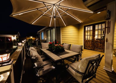 Cozy outdoor seating area with an umbrella and flowers