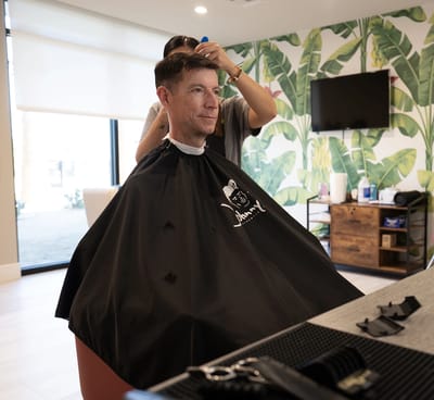 A resident receiving a haircut in a salon