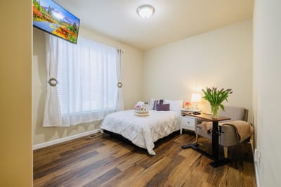Cozy private room with a bed and chair