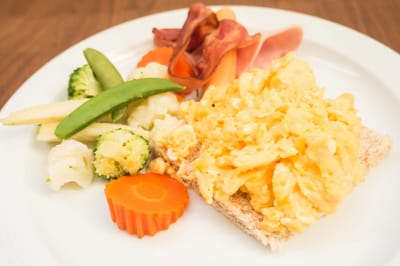 A plate of scrambled eggs and vegetables