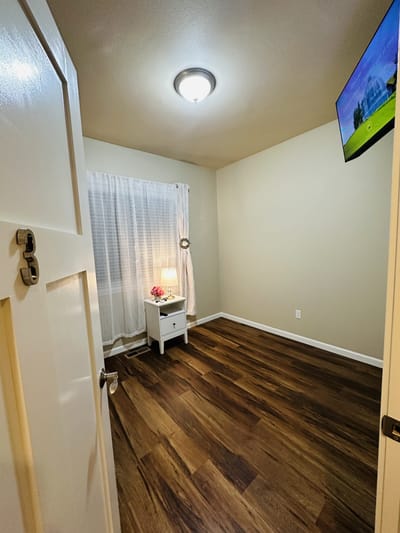 Bright private resident room with wooden flooring