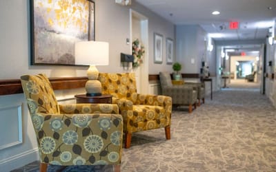A cozy hallway with decorative chairs and art