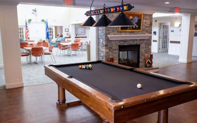 Billiard table in a common area with seating