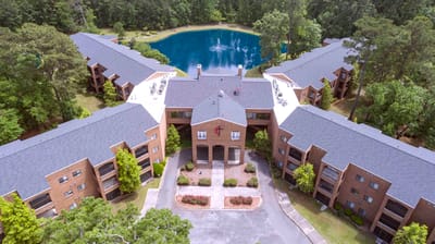 Aerial view of Magnolia Manor's residential buildings and pond