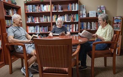 Residents reading in a cozy library area