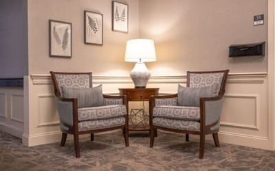 Cozy seating area with a lamp and artwork