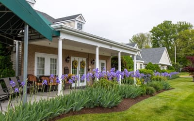 Exterior view of a senior living facility with flowers