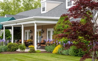 Exterior view of a senior living facility with blooming flowers