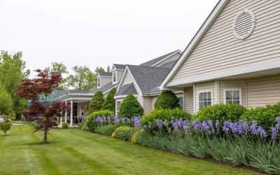 Exterior view of a senior living facility with landscaped gardens