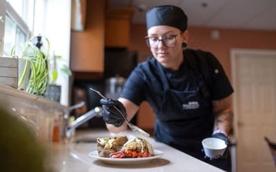 Staff member preparing a meal in the kitchen