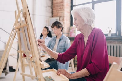 Residents enjoying an art class in a bright studio
