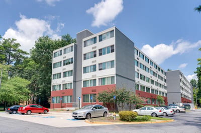 Exterior view of Lenox Summit Apartments surrounded by trees