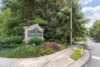 Entrance sign for Lenox Summit Apartments surrounded by greenery