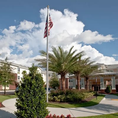 Exterior view of Kenwood Place Apartments with palm trees