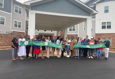 A group of people at a facility opening ceremony