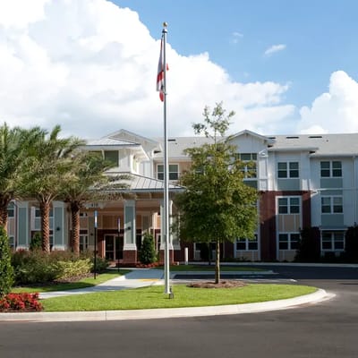 Exterior view of Kenwood Place Apartments with landscaping
