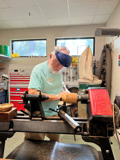 Resident engaged in woodturning activity in a workshop