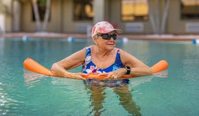 Senior woman enjoying a relaxing swim in the facility pool