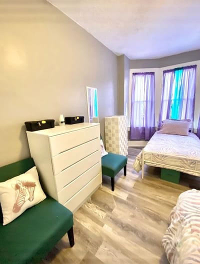 A well-furnished private resident room with beds and decor