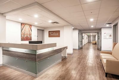 Bright reception area with seating and hallway