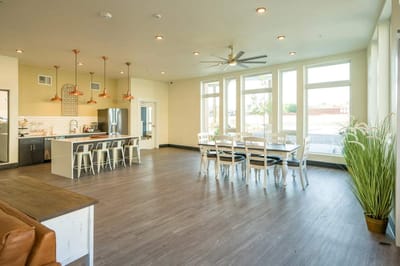 Bright common area with dining and kitchen space