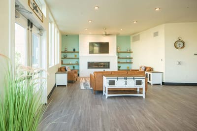 Bright common area with seating and a fireplace