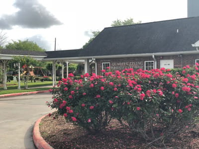 Exterior view of Quality Living Personal Care with flowers