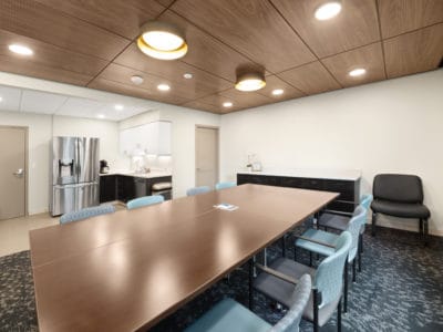 Bright common area with a large table and chairs