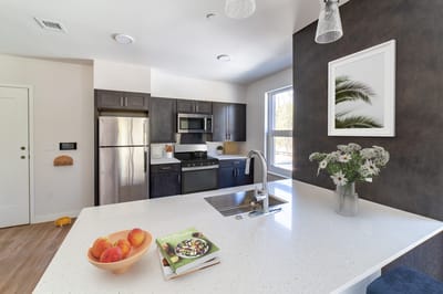 Modern kitchen with fruits and cooking book on the counter