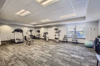A well-lit fitness room with exercise equipment
