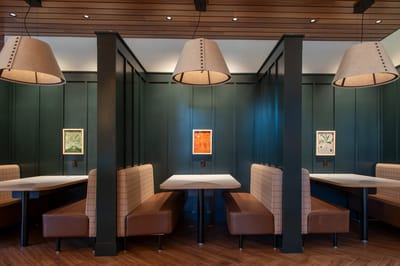 Interior dining area with cozy seating and artwork