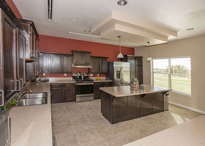 Modern kitchen area with dark cabinets and countertop