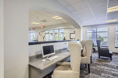 Modern common area with seating and computer stations