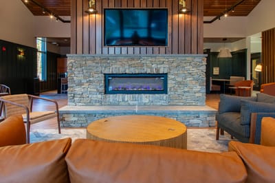 Cozy common area with comfortable seating and a modern fireplace